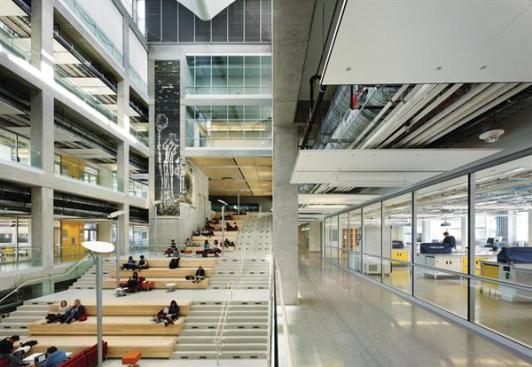 Glazed walls allow students sitting on the stairs to see into the laboratories and classrooms on the upper floors and out to the street beyond. The building ?is the size of a football field, but you can stand anywhere and see outside,? project manager-designer Rick Piccolo says.