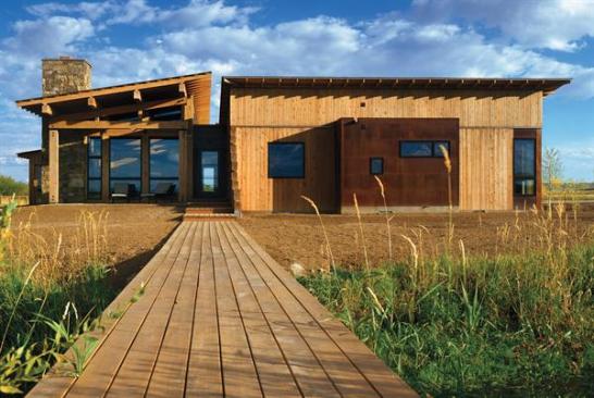Oxidized steel on the exteriors and waxed steel inside are smooth counterpoints to the abundant wood finishes throughout the house.
