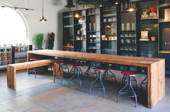 Custom pendant light fixtures and hand-stained wood furnishings define the interior of Atelier de LaFleur, a Tuscon wedding and event planning studio.