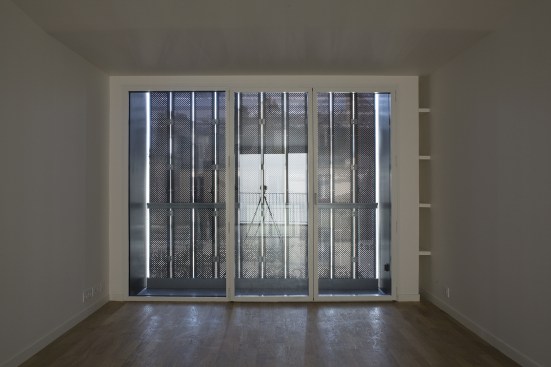 Like shutters on older French houses, the perforated panels admit light even when the windows are closed.