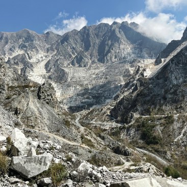 Evidence of surface mining and accompanying ravaneti deposits, seen from a distance.