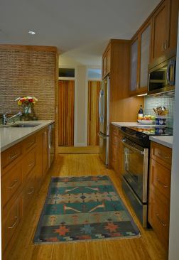 Features in the new modern kitchen include Whirlpool Energy Star appliances, concrete countertops made with 40% recycled content, 3form decorative panels, and Teragren bamboo flooring.