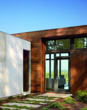 
  The
  Lecicester home is a modern and minimal example of architectural brilliance.
  The home is placed perfectly amongst its wide-open surroundings.  A broad range of standard Marvin window and
  door options were all carefully coordinated with the very professional Marvin
  team. The solution of a window wall along the south and west façades of the
  upper level brings the outdoors in. This custom configuration of standard
  Marvin products is integral to the vision of the house, as well as the
  economics of its construction. Punched windows in the lower level, also by
  Marvin, contrast nicely with the expression of the main living area. A
  continuous transom of glass at the entry façade allows morning light to
  dapple across the interior ceiling. The fenestration was integral to the very
  premise of the house, unifying the interiors with the site’s mountain
  views. 