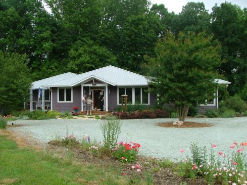 Completed in 2008, this M Squared house integrates with its wooded, lakeside lot via porches on three sides and bright, native landscaping.