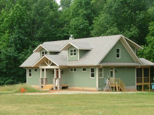 The newer of the M Squared homes, recently completed, boasts geothermal heating, Solaris reflective shingles, tankless water heating, and rain barrels.