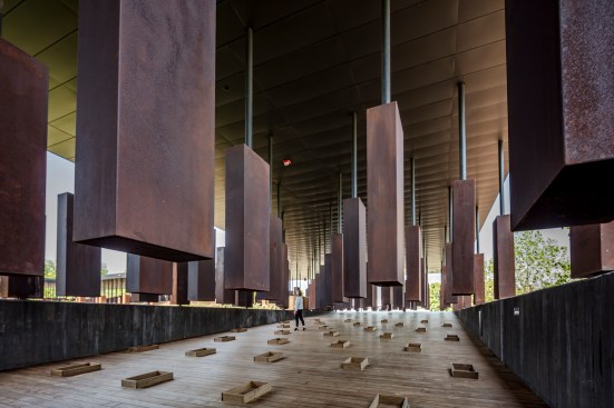 Six-foot-tall Cor-Ten steel slabs hang at the memorial site