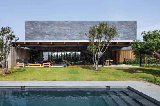 The main house is located in the back, at the north end of the site, making room for an expansive yard which includes seating areas, a pool,&nbsp;an outdoor kitchen, and a service building with a pantry and restrooms.