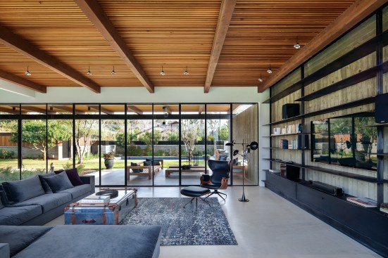Large glass doors offer direct access to the outdoor seating and dining areas. The pergola nearly doubles the square footage of the ground floor.