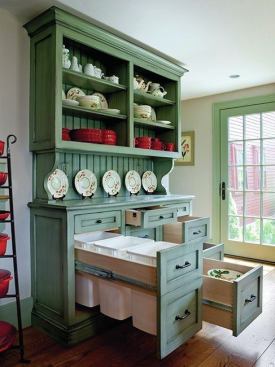 The hutch has three large drawers set back into the space under the stairs — one for recycling, two for storage — mounted on Accuride (accuride.com) full-extension glides. The recycling center and the two drawers to the right are 48 inches deep, but the top left drawer is shallower to accommodate the stair stringer.