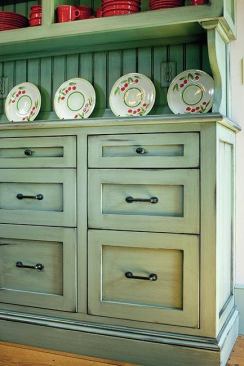 The hutch was pre-painted in the contractor’s shop and installed on site. The electrical outlets were cut on site and then a master painter painted the outlet covers — including adding faux beadboard lines.