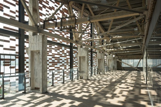 A balcony at the building's eastern end, behind the new brick screen