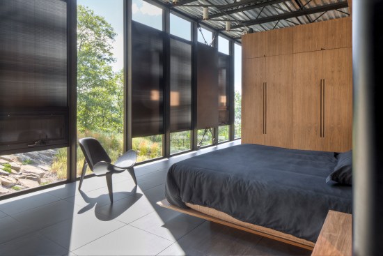 A bedroom at the north end of the house is flooded with light—sometimes too much. Bargmann is considering installing roller shades in addition to the fixed sunshades shown here.