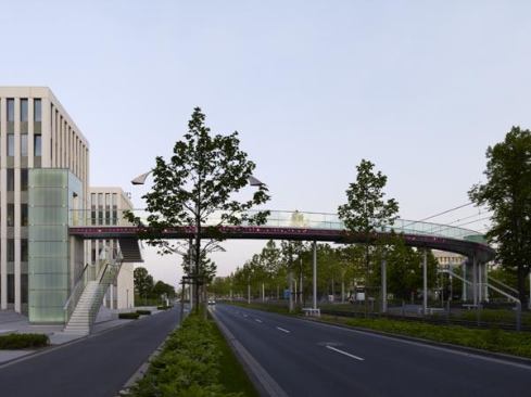 Five slim steel columns support the flat path that forms one grand curve across the traffic pathway.