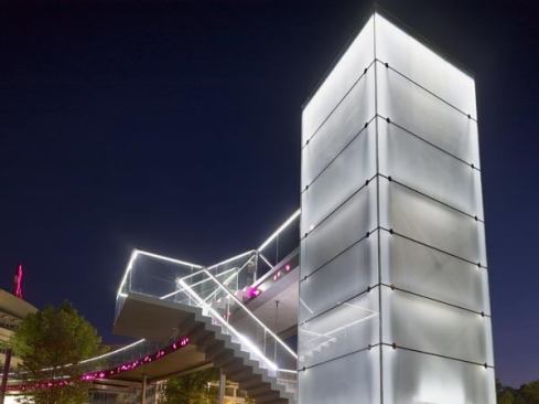 The opal glass cladding of the elevator towers is backlit with linear LED arrays.