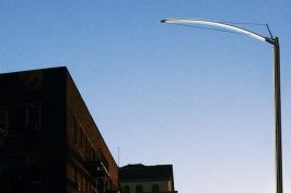 Light is also directed by the curved shape of the fixture's housing, one of the object's distinctive aesthetic features.