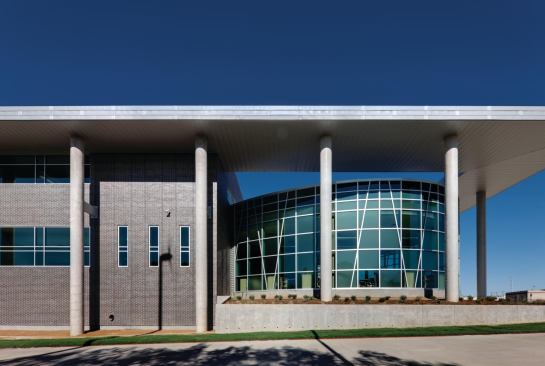 Windows stretch one-and-a-half stories in Lady Bird Johnson Middle School's southwest corner, allowing ample light into the library.