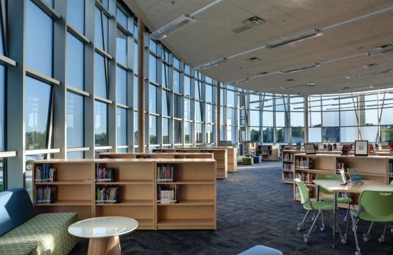 Windows stretch one-and-a-half stories in Lady Bird Johnson Middle School's southwest corner, allowing ample light into the library.
