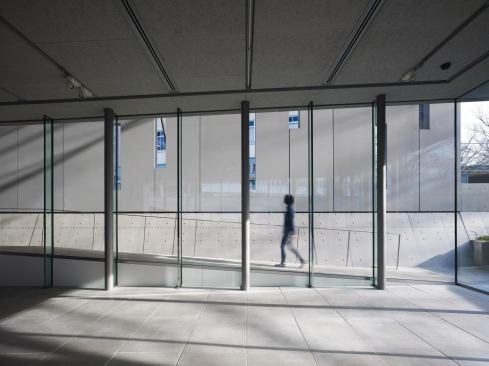 The glazed wall of the lower-level multipurpose space offers views out to the beginning of the museum’s ramp system.