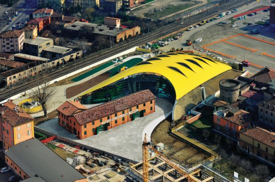The vivid yellow shell of the new Enzo Ferrari Museum is made from 5,000 extruded aluminum pieces, fitted together with tongue-and-groove joinery by shipbuilders—the same way one would assemble the hull of a ship. The shell is pierced by 10 fins to create computer-controlled skylights that vent warm air during the day.
