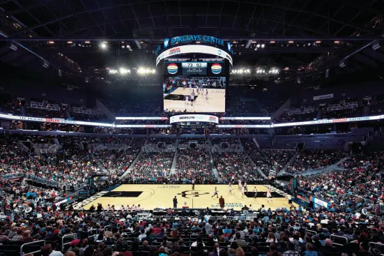 With black seats, walls, floors, and ceiling, the main bowl of the arena is a multifunctional space (here hosting an exhibition game for the Harlem Globetrotters) that can seat nearly 18,000 for a Brooklyn Nets game and 19,000 for a concert.