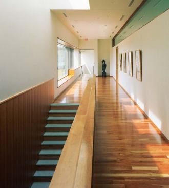 At the top of the stairs, a sunny gallery showcases works of art.