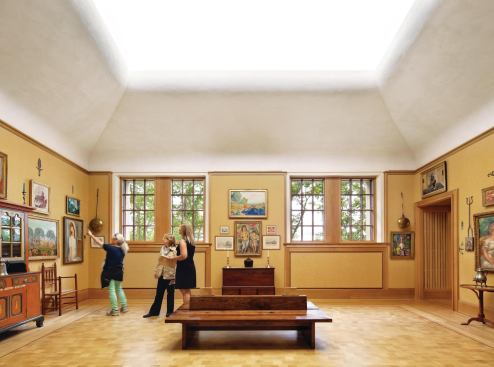 In the galleries on the second floor, T5s concealed in the coves of the clerestories provide additional indirect light to each space.