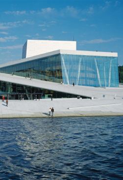 OSLO OPERA HOUSE, Oslo, Norway


Zoë Ryan, Neville Bryan Curator of Design, Art Institute of Chicago

"The Oslo National Opera House, which opened in April 2008, appears to erupt from the Oslofjord like a giant iceberg. The vision of local architects Snøhetta, the five-story building is a complex facility that houses the Norwegian Opera and National Ballet. Openness and accessibility are achieved through the design, which sweeps up from the water and results in a strikingly angular structure ramped over with a public space—the main gathering space in this formerly industrial part of the city. Whether attending a performance or not, the public can access the ramped plaza and look down into the building through a series of glass towers that punctuate the surface, further encouraging interactivity between inside and outside."


Andres Lepik, Curator of Architecture and Design, Museum of Modern Art, New York

"The new opera house in Oslo is a terrific building. Its concept and urban setting make it a touchstone for the buildings that are yet to be built in this area, in the former harbor. It was a brilliant idea to open its various workshops to the passersby. The interior creates a very intimate and warm feeling, and the various zones of the building afford intense views of the surrounding area. It is a building that can be experienced as much with the eyes as with the heart."