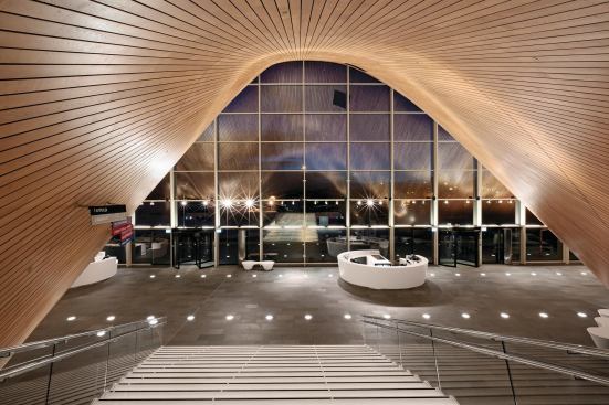The façade curves draw visitors into the performance halls as if they wer "being sucked in a cave," ALA partner Samuli Woolston says.