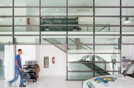 Stairs lead to a second level with workstations and storage space.