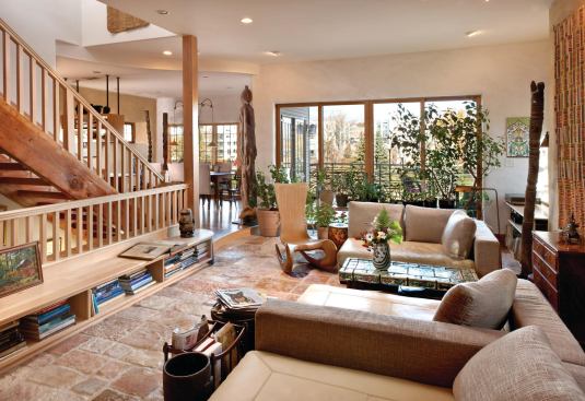 Warm, well-worn materials add character and up the sustainability quotient, including reused stone flooring and bookshelves and trim made of salvaged lumber from a nearby teardown.