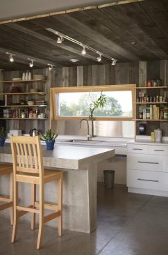 Weathered barn boards on the north wall and ceiling of the kitchen add warmth and definition to the overall common area.