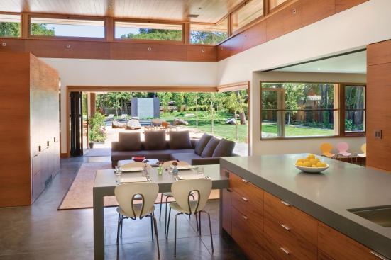 Accordion doors link the kitchen to the backyard and pool area.