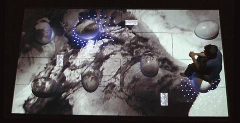 Three video monitors dispersed across and recessed into the platform allow visitors to view the video at a smaller scale and without any projected abstraction.