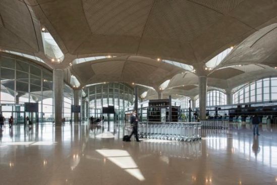 The interiors are airy, with daylight spilling through the glazed perimeter walls and through louvered skylights in the vaulted ceiling. “We illuminated the interior with indirect sunlight by filtering daylight through split beams at the junctions between the concrete domes—the effect is a little like a desert palm, whose leaves extend and widen from very slender branches close to the trunk,” Parr says. The underside of each shallow dome is inscribed with a linear pattern that recalls the fronds of palm leaves, as well as examples from Islamic art.