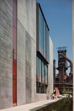 The east façade is clad largely in precast concrete wall panels with a hand-screed finish.