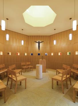 A side chapel for meditation has a skylight, and recessed fixtures re-create this lighting at night. Stained-glass window niches provide additional perimeter lighting in this and the main sanctuary, and triple-headed LED fixtures light these small cutouts at night.