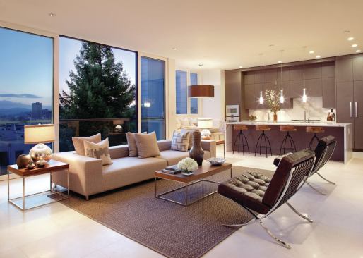 An open kitchen/family room with a breakfast bay and a counter for casual dining stretches the width of the house. A full story above grade at the rear of the building, the room enjoys elevated city views.