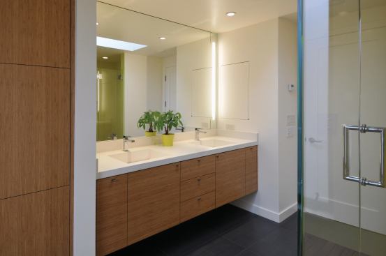 The master bathroom features a Concreteworks countertop, Woodmaster custom cabinetry made with Teragren Synergy bamboo, and Toto Aquia dual-flush toilets.