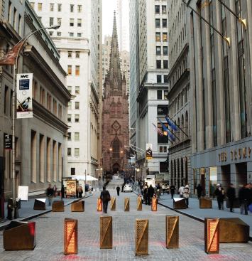 The turntables have been in place in New York's financial district since last year, replacing clamshell barriers that limited pedestrian access and disrupted the view. Integrated light panels signal to drivers whether or not the street is passable. The perforated-bronze cladding mimics the finish of the existing sidewalk barriers.

