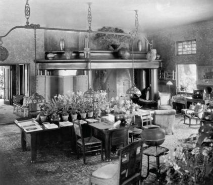 Tiffany selected every detail and feature of his interiors to create a harmonious environment. For the dining room, he combined floral patterned walls and leaded glass windows trailing with wisteria vines to obscure the boundary between indoors and out.