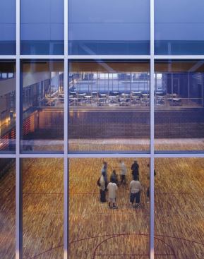 The cafeteria's glass interior wall allows views into the gym.
