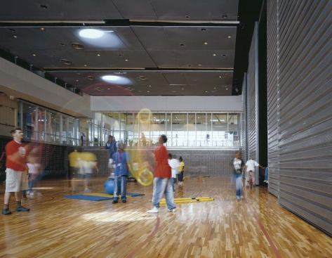 A mechanical system converts the gym into an auditorium with tiered seating in about a minute.