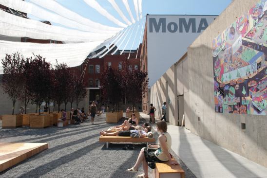 The PS1 courtyard is sheltered by a fabric canopy that ties into the museum's concrete wall. When Holding Pattern comes down in the fall, its benches, lounges, and ping-pong tables will be distributed to new homes.