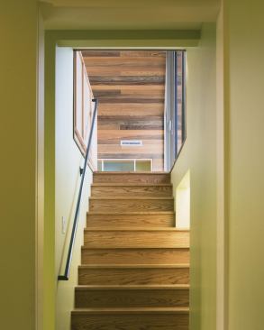 The stairway to the new playroom, inserted into the oversize garage volume.