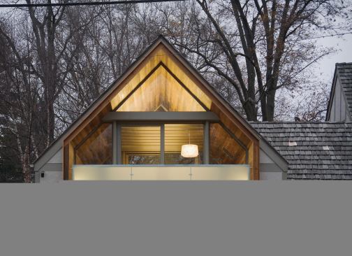 The playroom’s wooden “tube,” clad in 100-year-old sinker cypress, is extruded to create a balcony.
