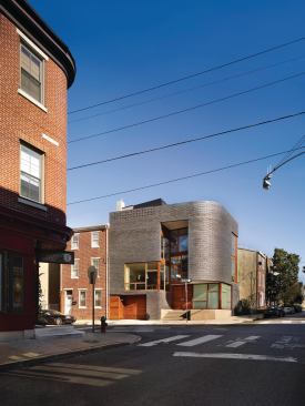 The bullnose facade references other corner buildings on the street.

