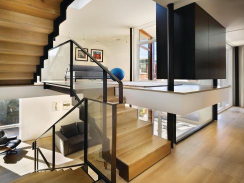 Blackened oak storage consoles double as room dividers throughout the house.
