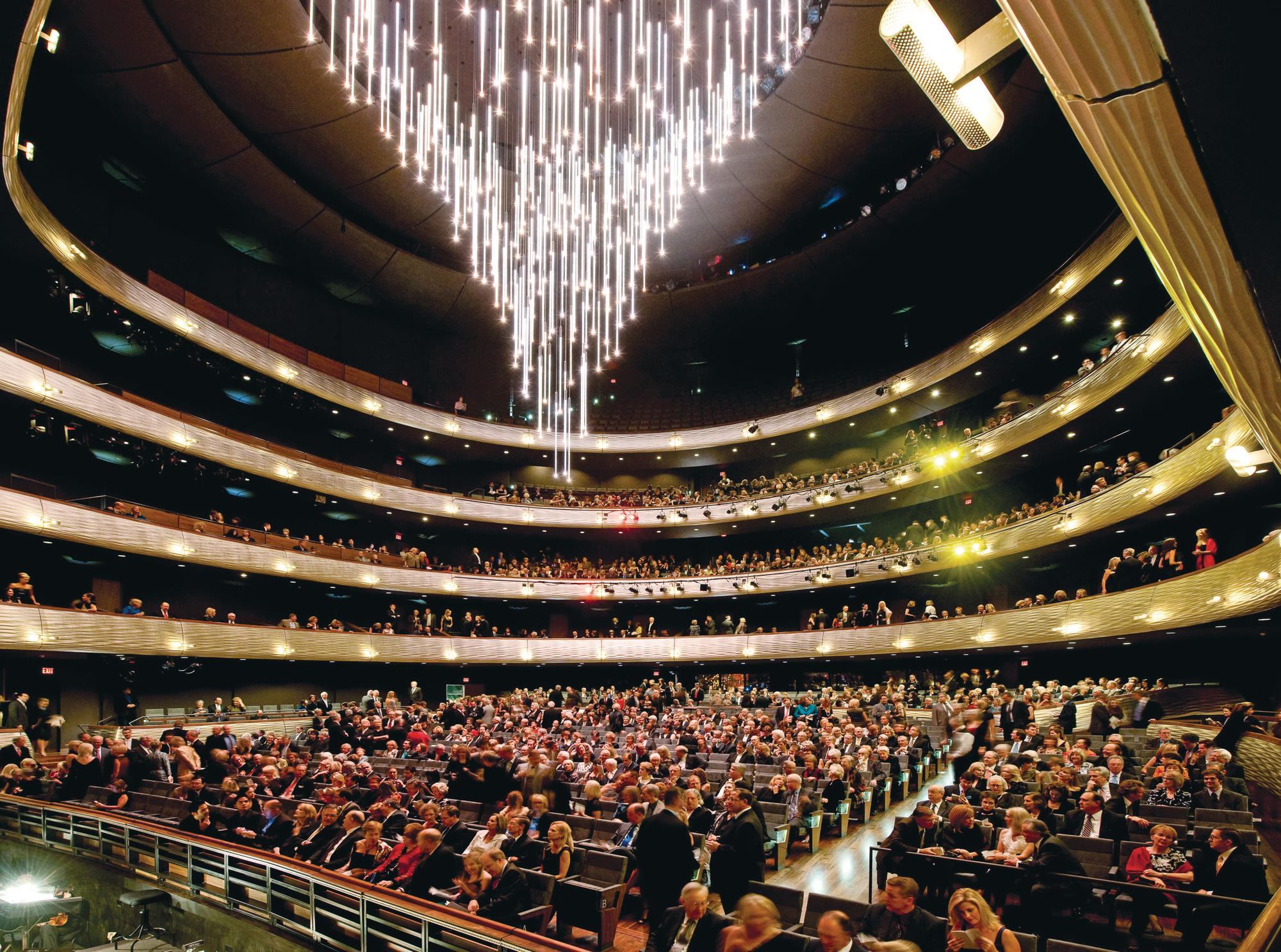 The drum houses a traditional horseshoe-shaped theater with an acrylic-rod chandelier that retracts when performances start.