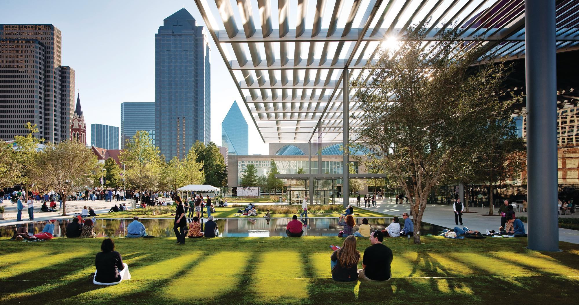 Visitors relax in Dallas’ new 10-acre Elaine D. and Charles A. Sammons Park, designed by French landscape architect Michel Desvigne. At right is the new opera house by Foster + Partners; its monumental canopy extends into, and provides shade for, the park.