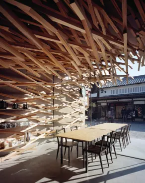 Seating and store display areas at the front of the Starbucks store look out onto the neighboring shops.